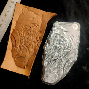 Bear head warrior leather stamp mold with embossed vegetable-tanned leather sample and ruler