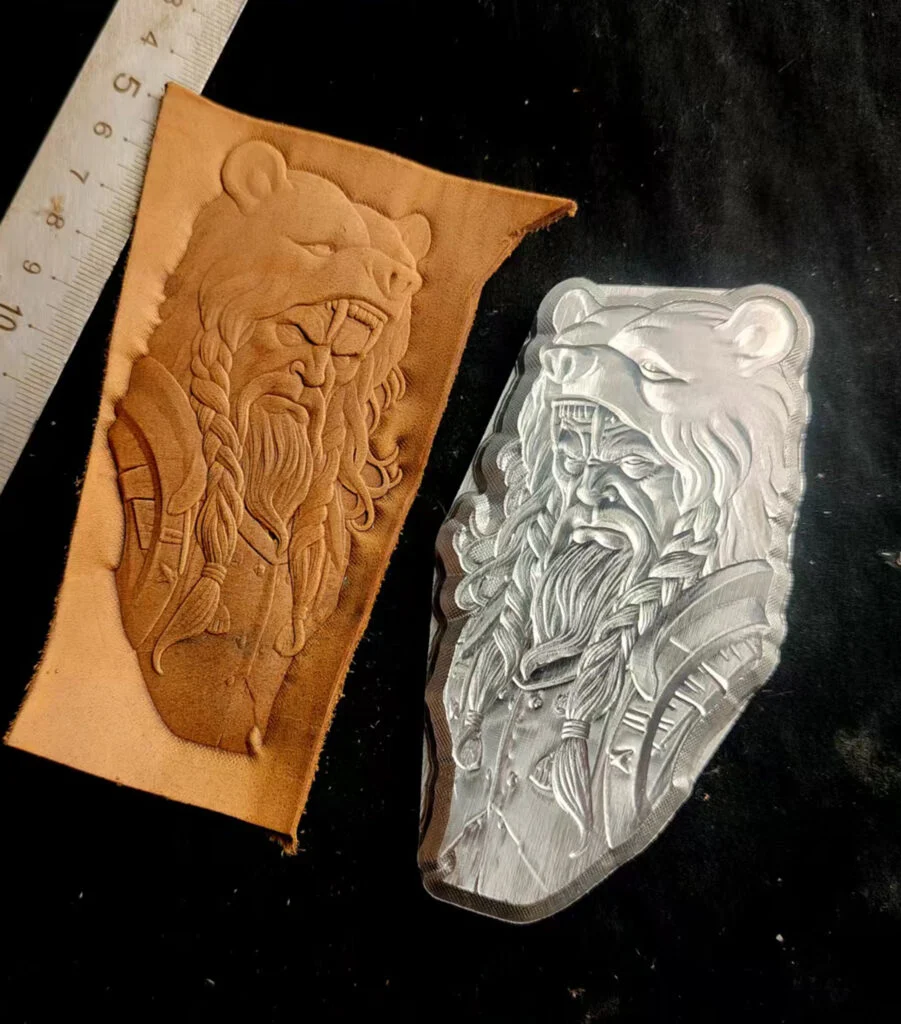 Bear head warrior leather stamp mold with embossed vegetable-tanned leather sample and ruler