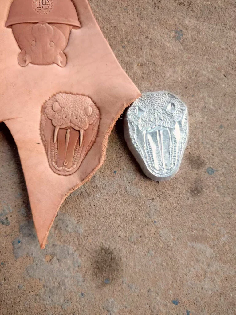 Snake leather stamp mold in 2A12 duralumin with embossed leather sample