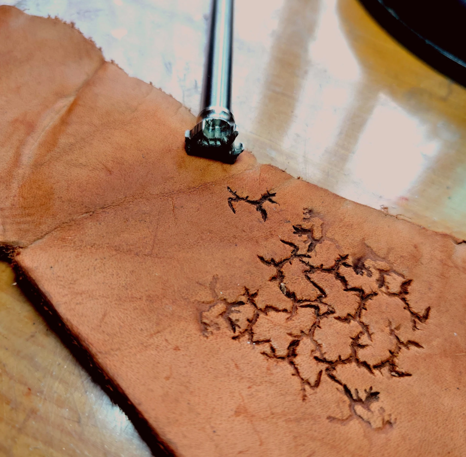 close up of crater texture leather stamp detail