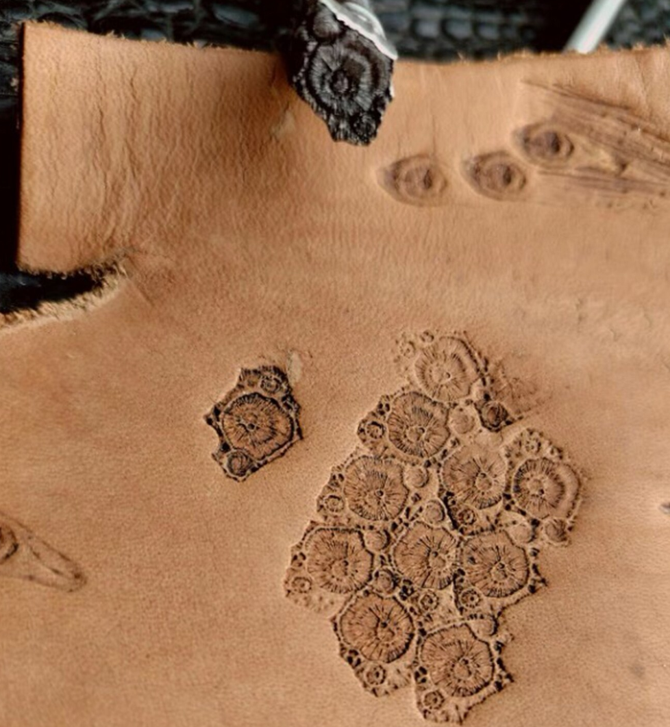 close up of crater texture leather stamp detail