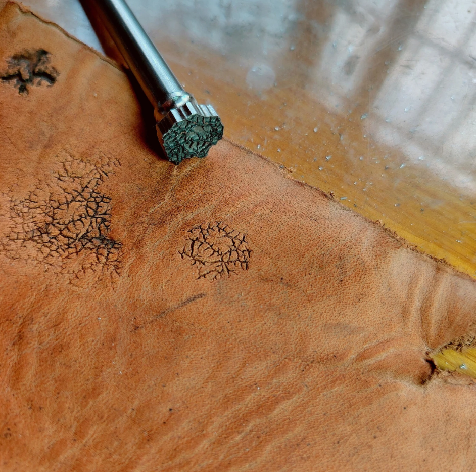 close up of crater texture leather stamp detail