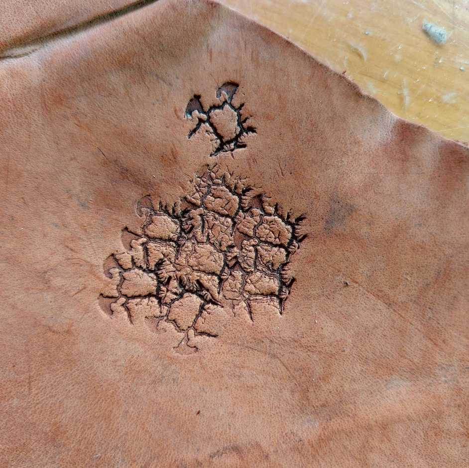 close up of crater texture leather stamp detail