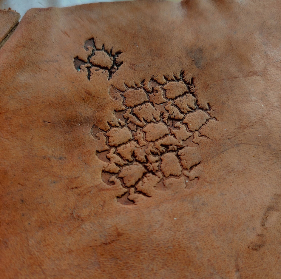 close up of crater texture leather stamp detail