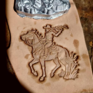 Cowboy on horseback leather stamp mold embossed on leather sample