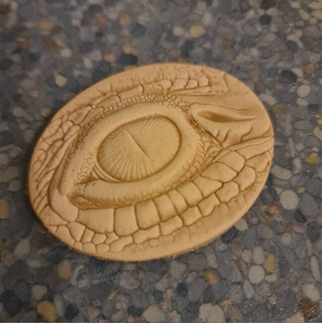 Dragon eye impression pressed into leather by a customer